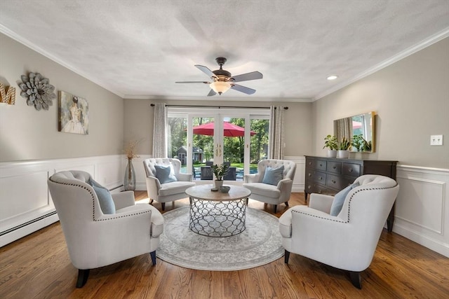 1 Liberty Ln, North Reading, MA 01864 - living room featuring wainscoting, ornamental molding, wood finished floors, a decorative wall, and ceiling fan