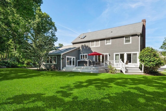 1 Liberty Ln, North Reading, MA 01864 - rear view of property with a chimney, a yard, and a deck