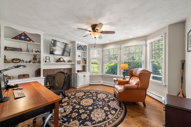 1 Liberty Ln, North Reading, MA 01864 - office featuring a baseboard radiator, a ceiling fan, plenty of natural light, light wood finished floors, and a textured ceiling