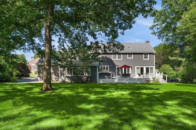 1 Liberty Ln, North Reading, MA 01864 - rear view of house with a lawn, a deck, and a chimney