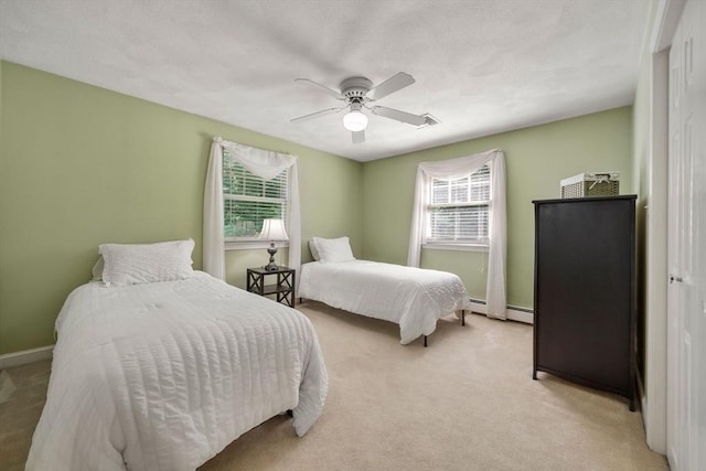 1 Liberty Ln, North Reading, MA 01864 - bedroom with light carpet, a ceiling fan, and a baseboard heating unit