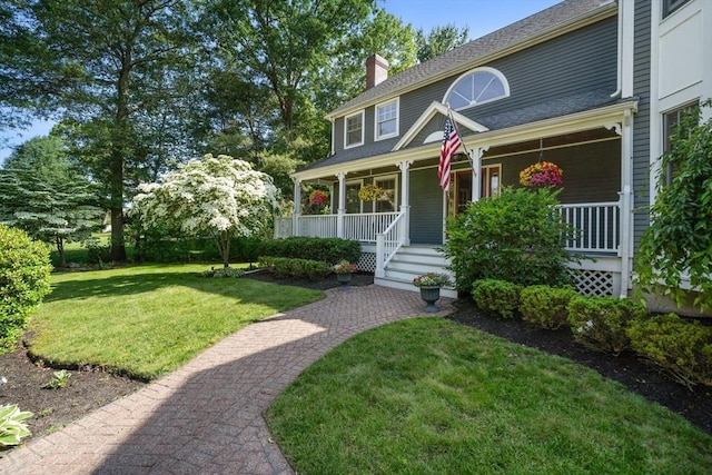 1 Liberty Ln, North Reading, MA 01864 - view of front of house with a chimney, a front lawn, and covered porch