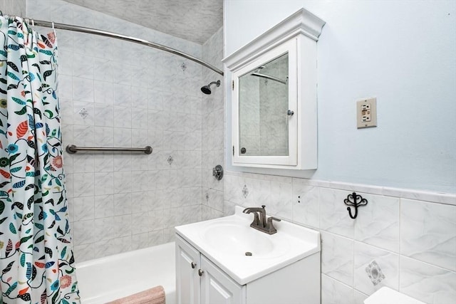 full bath featuring vanity and tile walls