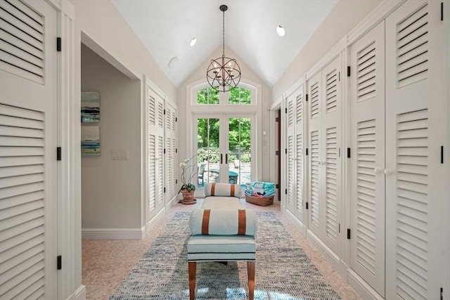 interior space featuring a chandelier, baseboards, vaulted ceiling, and french doors