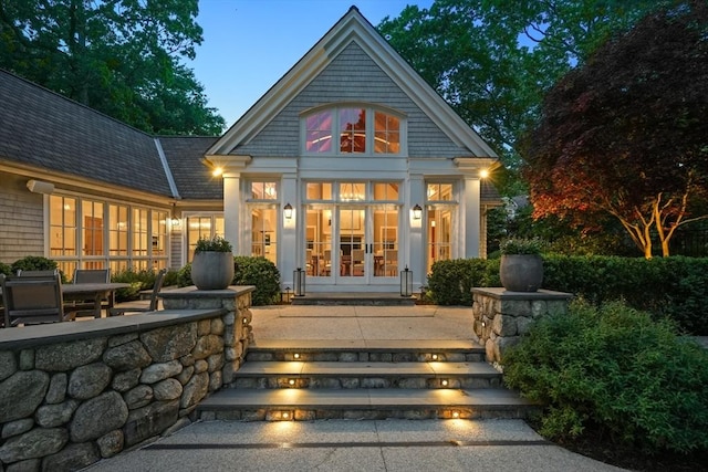 back of house at dusk with french doors