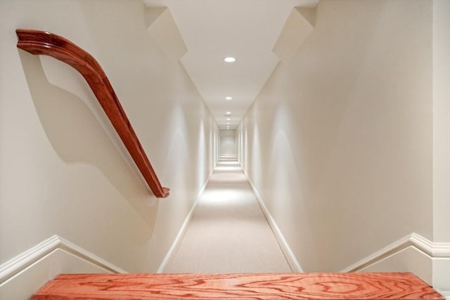 hall with carpet floors, recessed lighting, and baseboards