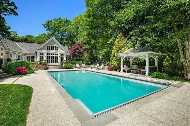 outdoor pool featuring a patio area, a gazebo, a storage structure, and an outdoor structure