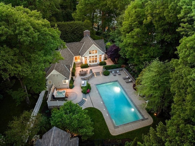 view of pool featuring a patio area, an outdoor structure, and a storage structure