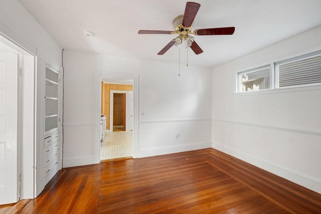 unfurnished bedroom featuring dark wood-type flooring and ceiling fan