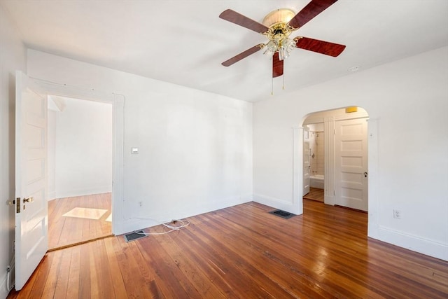 empty room with hardwood / wood-style floors and ceiling fan