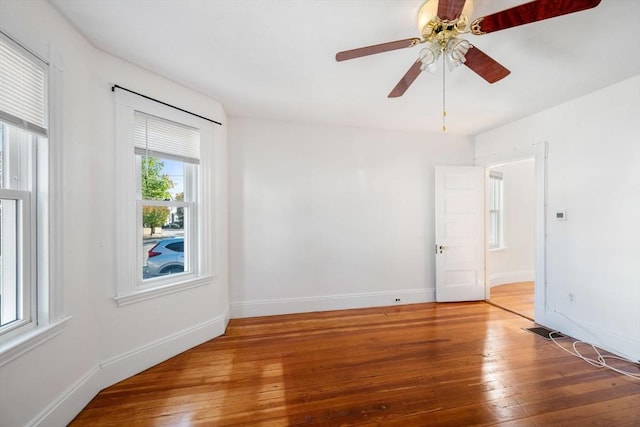 spare room featuring hardwood / wood-style floors, plenty of natural light, and ceiling fan