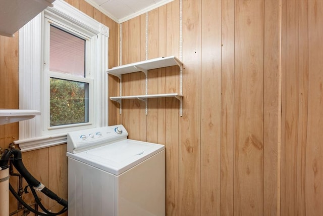 washroom with crown molding, washer / dryer, and wooden walls