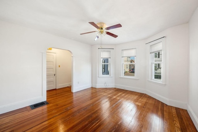 empty room with hardwood / wood-style floors and ceiling fan