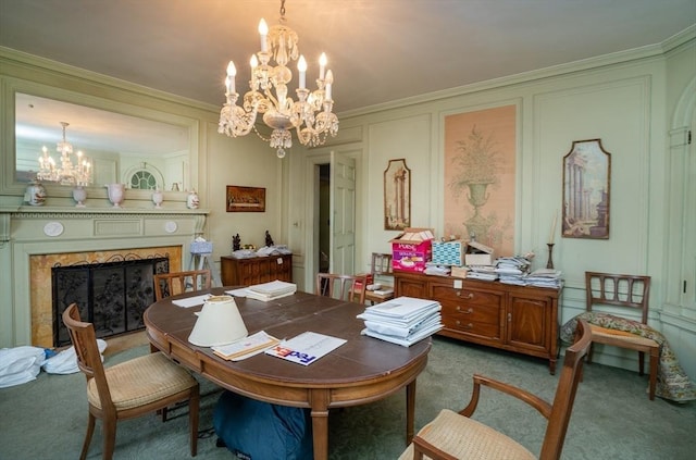 carpeted dining area featuring a notable chandelier, ornamental molding, a fireplace, and a decorative wall