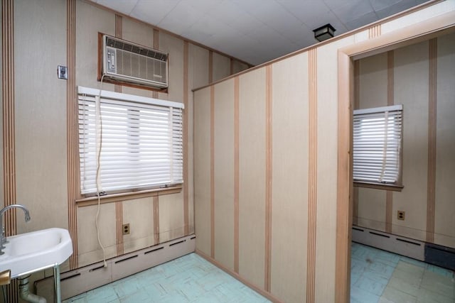 bathroom featuring tile patterned floors, baseboard heating, and a wall mounted AC