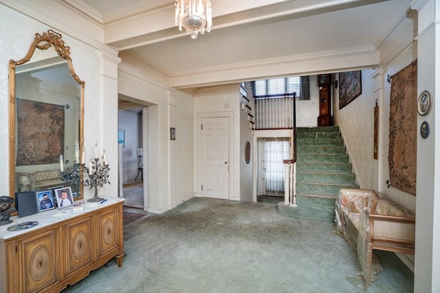 foyer entrance featuring stairway, ornamental molding, and carpet flooring