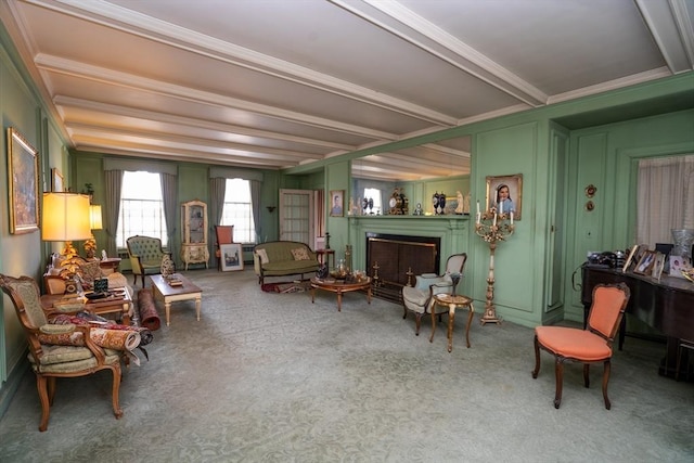 interior space with beamed ceiling, ornamental molding, a fireplace, and carpet floors