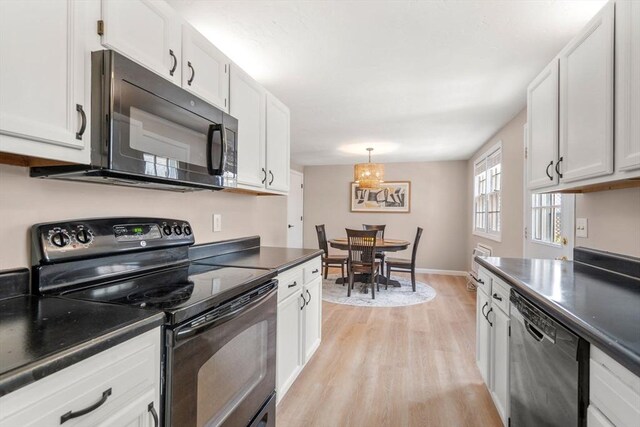 47 Plantation Rd Unit 47, Oxford, MA 01540 - kitchen with white cabinetry, dark countertops, black appliances, and light wood finished floors