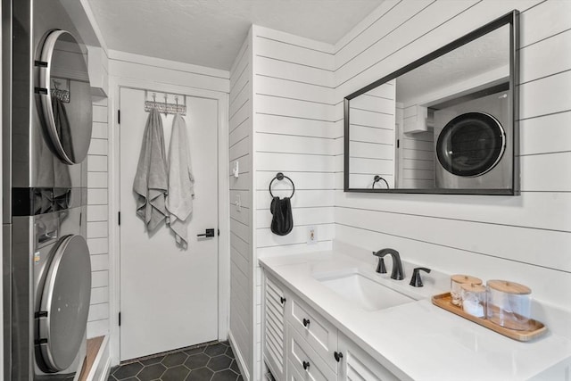 47 Plantation Rd Unit 47, Oxford, MA 01540 - bathroom with stacked washer and clothes dryer, wood walls, a shower, and vanity