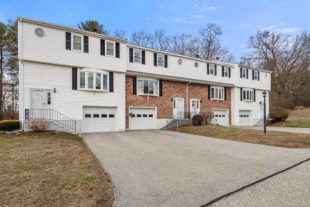 47 Plantation Rd Unit 47, Oxford, MA 01540 - raised ranch with an attached garage, brick siding, and aphalt driveway