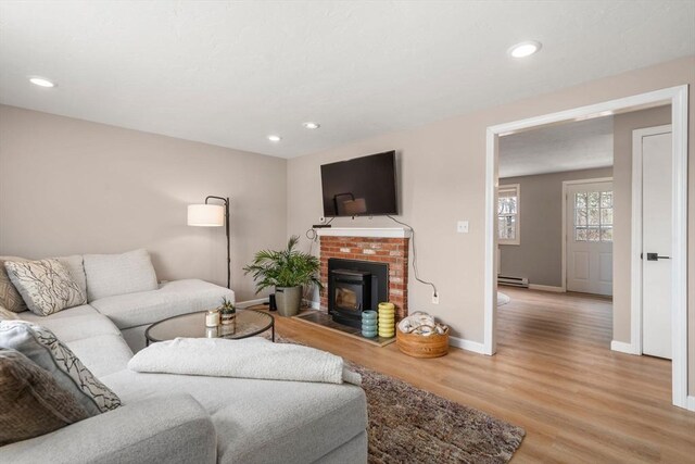 47 Plantation Rd Unit 47, Oxford, MA 01540 - living room with a brick fireplace, baseboards, recessed lighting, baseboard heating, and light wood-style floors