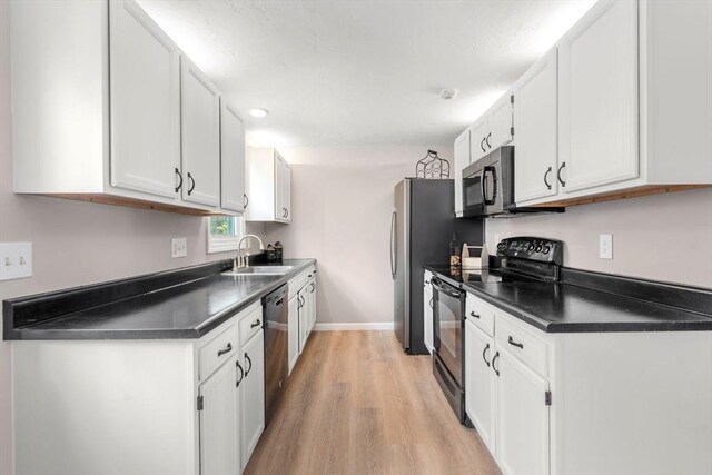 47 Plantation Rd Unit 47, Oxford, MA 01540 - kitchen with stainless steel dishwasher, dark countertops, black range with electric cooktop, and a sink
