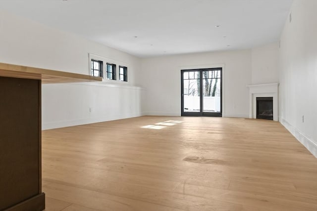 unfurnished living room with light hardwood / wood-style flooring