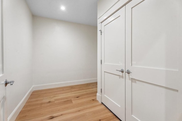 corridor with light wood-type flooring