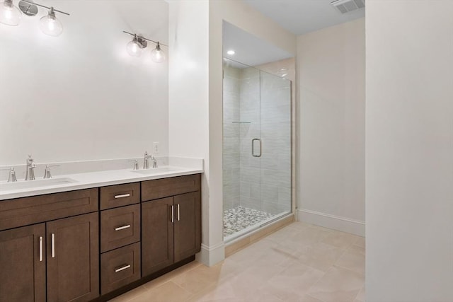 bathroom with tile patterned flooring, vanity, and a shower with shower door