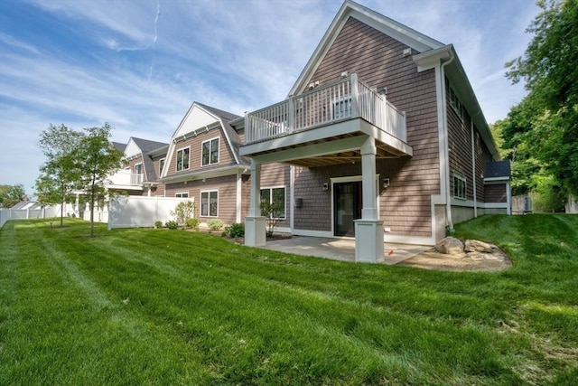 rear view of house with a yard, a patio, and a wooden deck