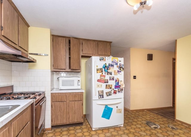 177 Pine Hill Cir, Waltham, MA 02451 - kitchen featuring white appliances, light countertops, tasteful backsplash, baseboards, and under cabinet range hood