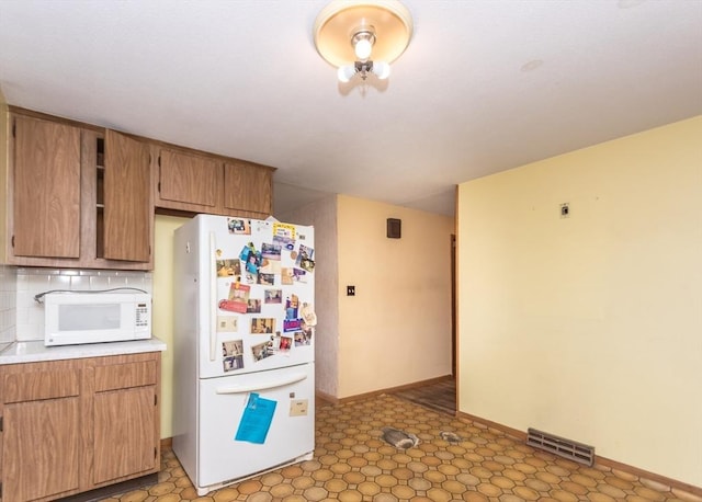 177 Pine Hill Cir, Waltham, MA 02451 - kitchen featuring white appliances, light countertops, baseboards, and tasteful backsplash