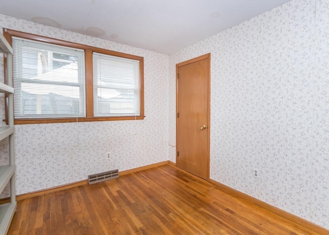 177 Pine Hill Cir, Waltham, MA 02451 - empty room featuring wood finished floors, wallpapered walls, and baseboards