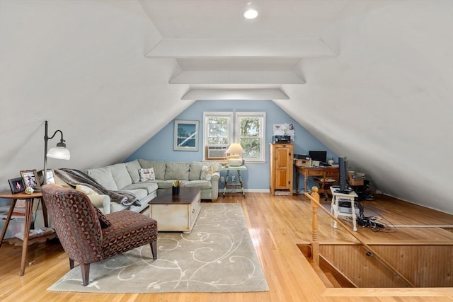 additional living space with vaulted ceiling with beams, cooling unit, and wood finished floors