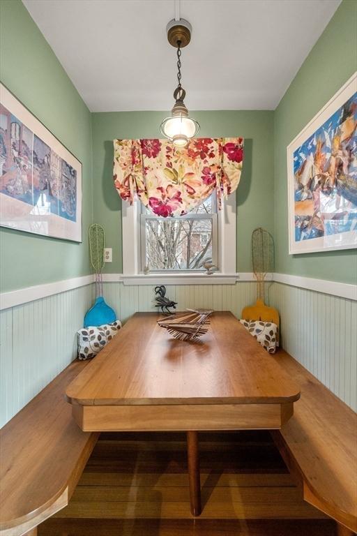 dining area featuring breakfast area and a wainscoted wall