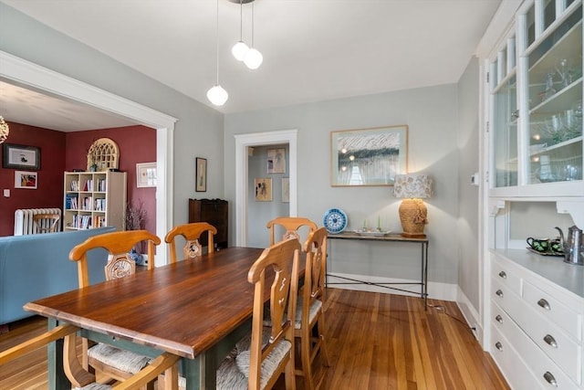 dining room with baseboards and wood finished floors