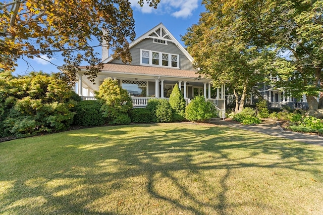 view of front of house with covered porch and a front yard