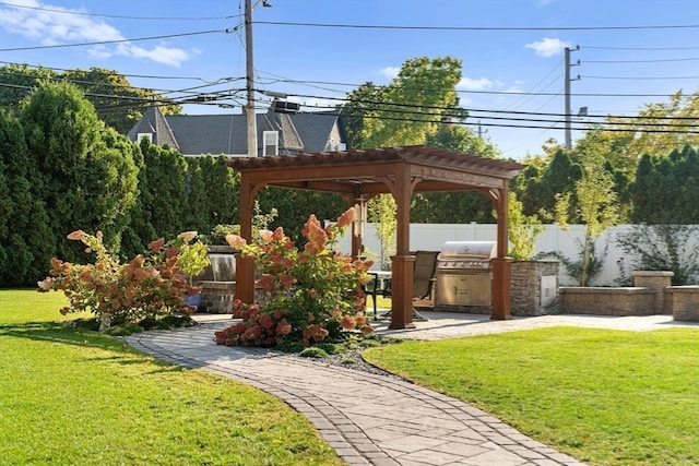 exterior space with a grill, a pergola, and an outdoor kitchen