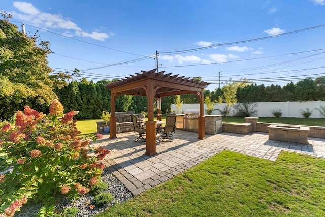 exterior space with a pergola, exterior kitchen, and an outdoor fire pit