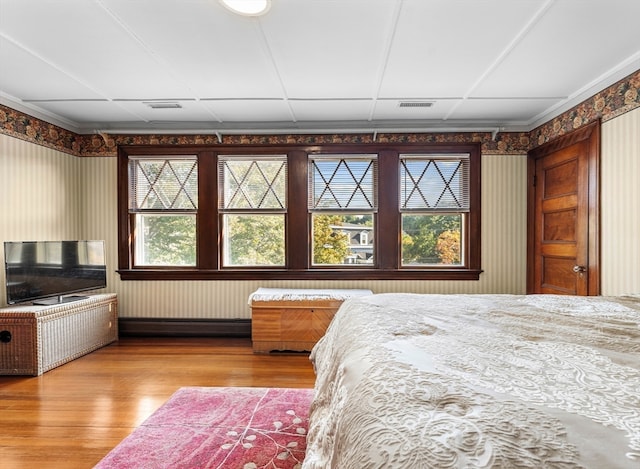 bedroom featuring multiple windows and hardwood / wood-style floors