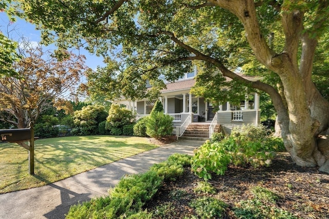 view of front of home with a porch and a front yard