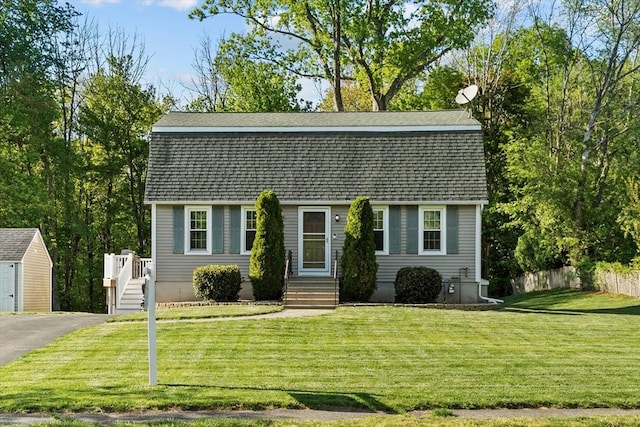 9 Buckingham Ln, Haverhill, MA 01835 - dutch colonial featuring an outdoor structure, a gambrel roof, a shingled roof, and a storage unit