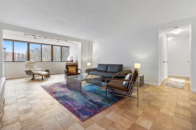 living room with rail lighting and baseboards