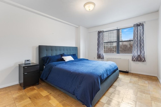 bedroom featuring radiator and baseboards