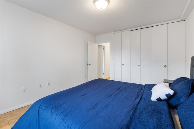 bedroom with a closet and baseboards