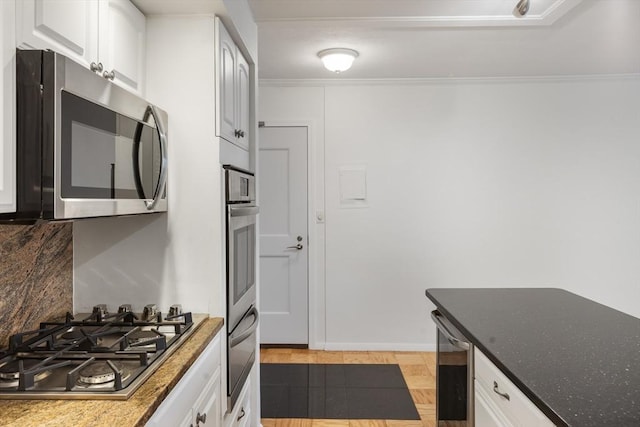 kitchen featuring beverage cooler, stainless steel appliances, backsplash, and white cabinets