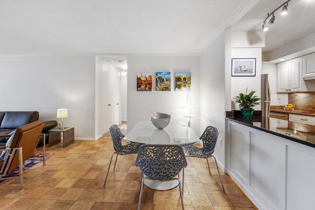 dining area featuring baseboards and crown molding