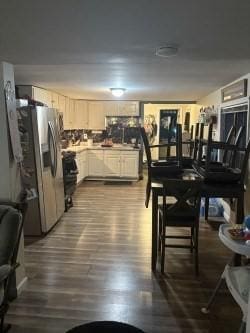 kitchen featuring stainless steel fridge with ice dispenser and dark wood-style flooring