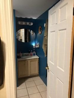 bathroom with tile patterned floors and vanity