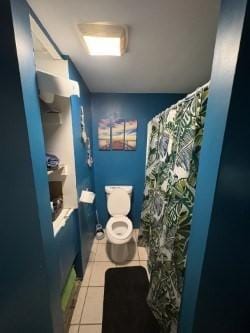 full bath featuring tile patterned flooring and curtained shower